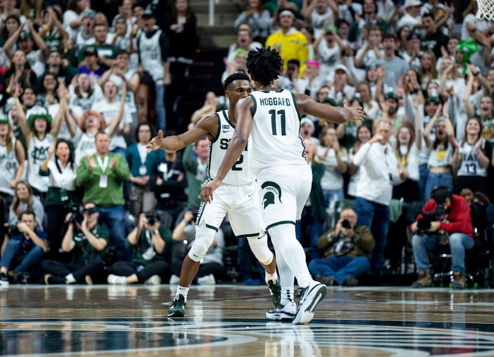 Senior guard Tyson Walker (2) and junior guard A.J. Hoggard (11) high-five during a game against Villanova at the Breslin Center on Nov. 18, 2022. The Spartans defeated the Wildcats 73-71. 