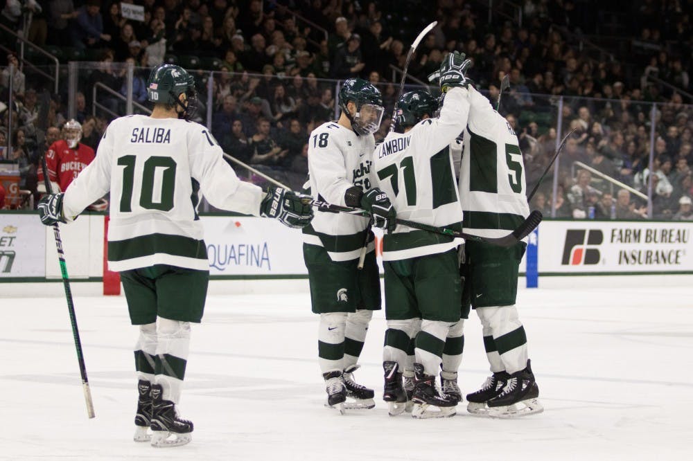The Spartans celebrate a goal during the game against Ohio State University at Munn Ice Arena on Jan. 4, 2018. The Spartans defeated the Buckeyes 8-7 in double overtime.