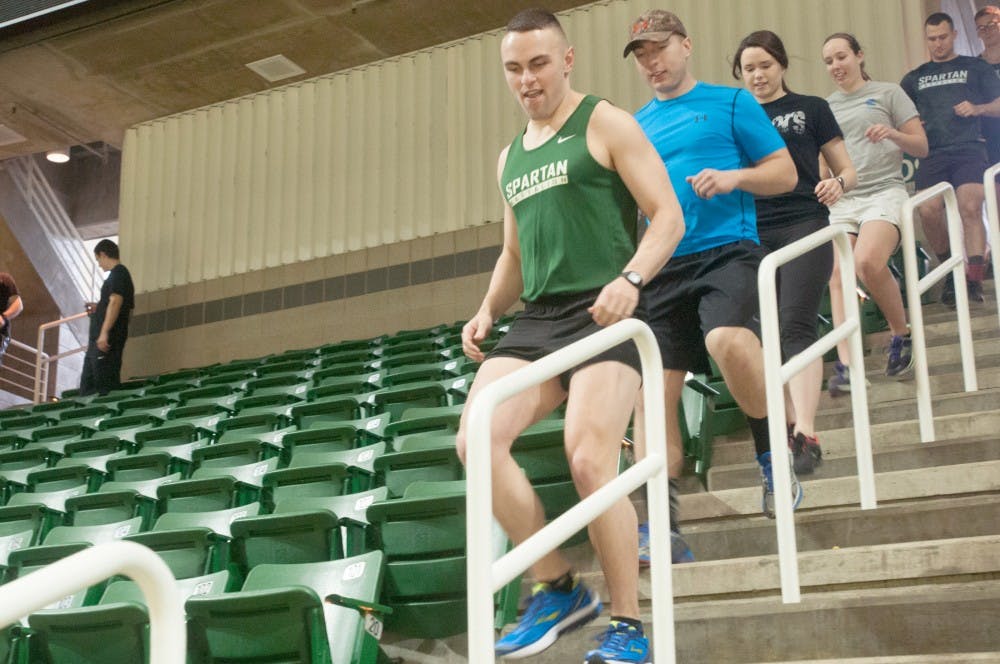 Applied engineering junior Collin Ganoon runs down the stairs Feb. 20, 2016 at Breslin Center. Gangnon was participating in the 2016 Klimb for Kids. 