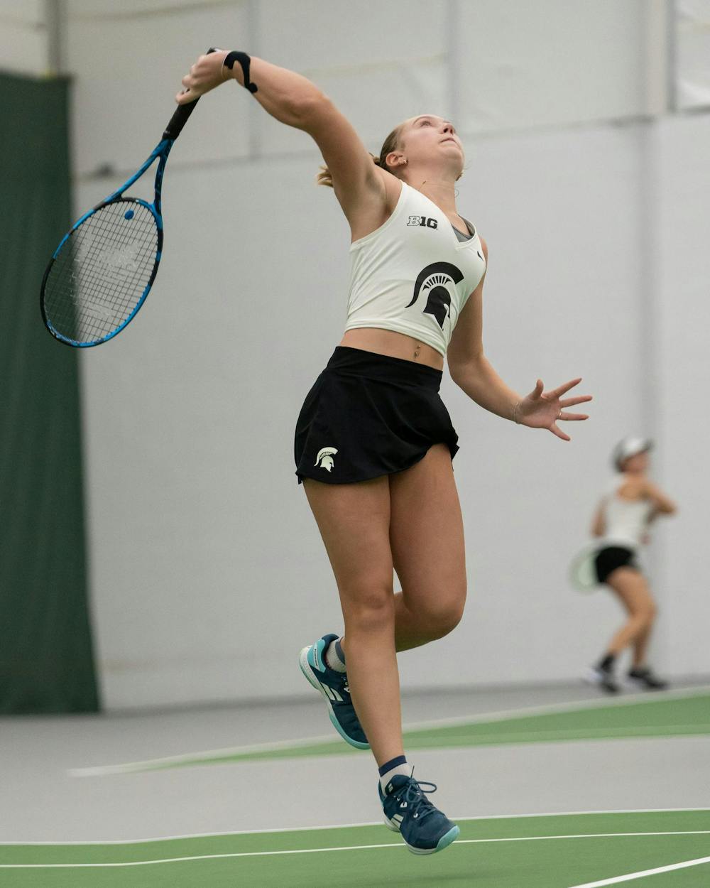 <p>MSU freshman Ellie Blackford jumps to hit the ball against Xavier at the MSU Indoor Tennis Center on Jan. 24, 2025. Blackford went on to lose the match six to three.</p>