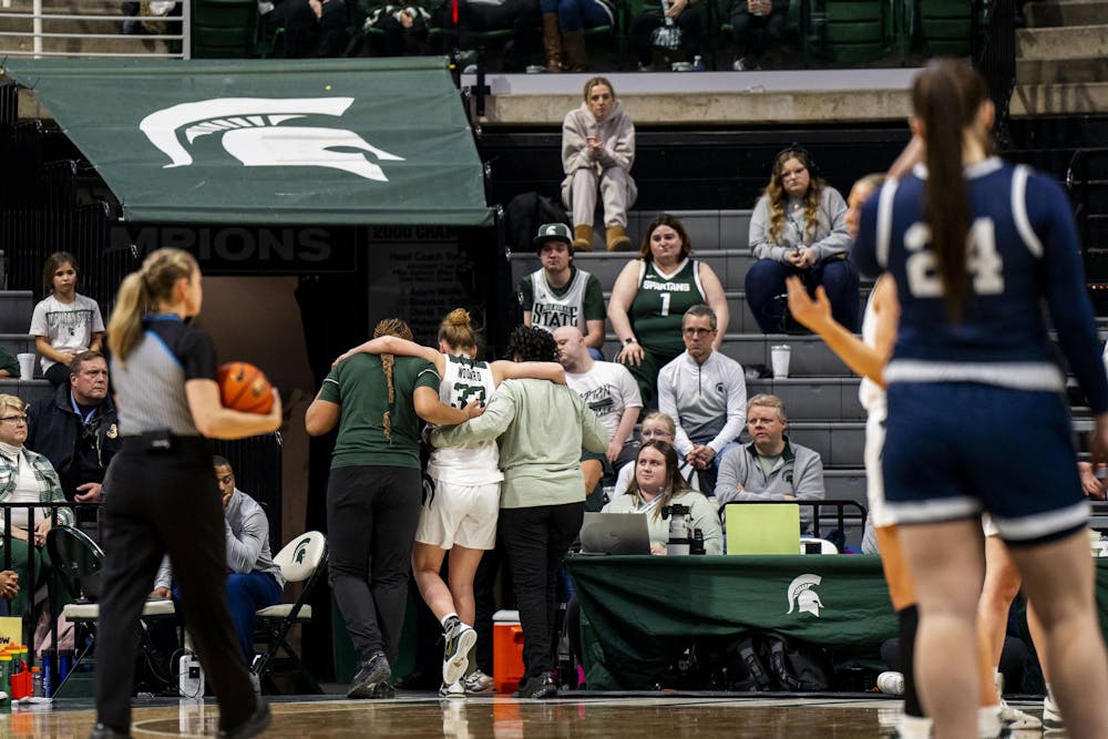 <p>Support staff help Michigan State University freshman forward Juliann Woodard (33) off the court after she gets injured at the Breslin Student Events Center on Jan. 22, 2025.</p>