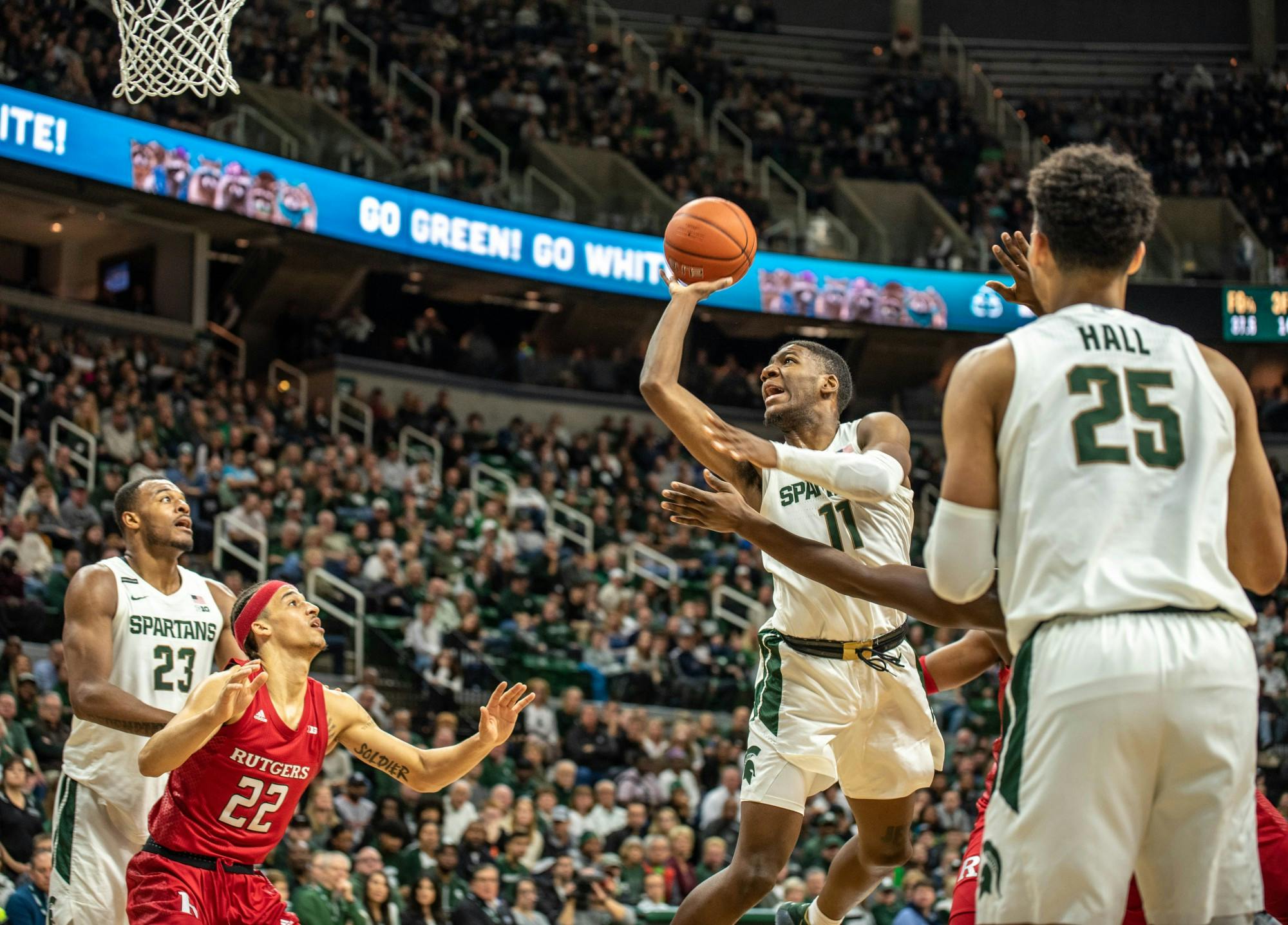 <p>Then-sophomore forward Aaron Henry (11) shoots the ball during the game against Rutgers at Breslin Center on Dec. 8, 2019. The Spartans lead the Scarlet Knights at halftime, 33-28.</p>