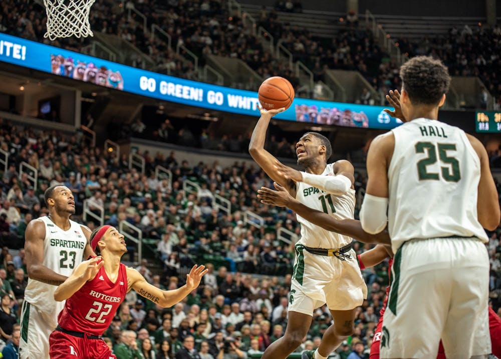 <p>Then-sophomore forward Aaron Henry (11) shoots the ball during the game against Rutgers at Breslin Center on Dec. 8, 2019. The Spartans lead the Scarlet Knights at halftime, 33-28.</p>
