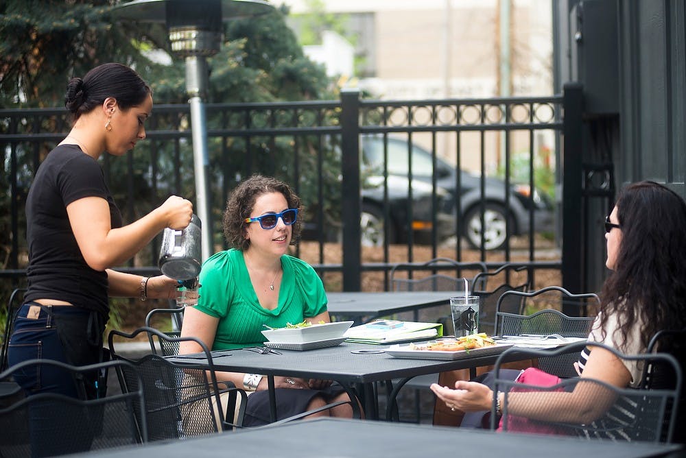<p>East Lansing residents Becky Jo Farrington, left, and Michelle Carlson dine May 21, 2014, at the Black Cat Bistro, 115 Albert Ave. The Bistro features some local dishes with local products. Hayden Fennoy/The State News </p>