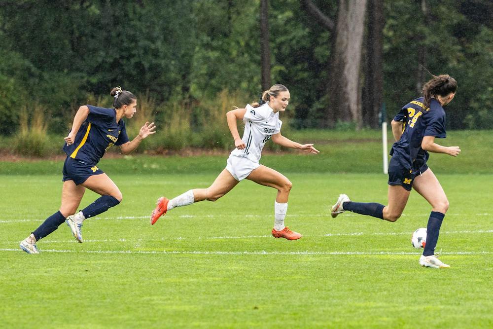 <p>MSU senior midfielder Emerson Sargeant (19) races against Michigan defenders as rain pours down at DeMartin Stadium in East Lansing, Mich., on Sept. 20, 2026.</p>