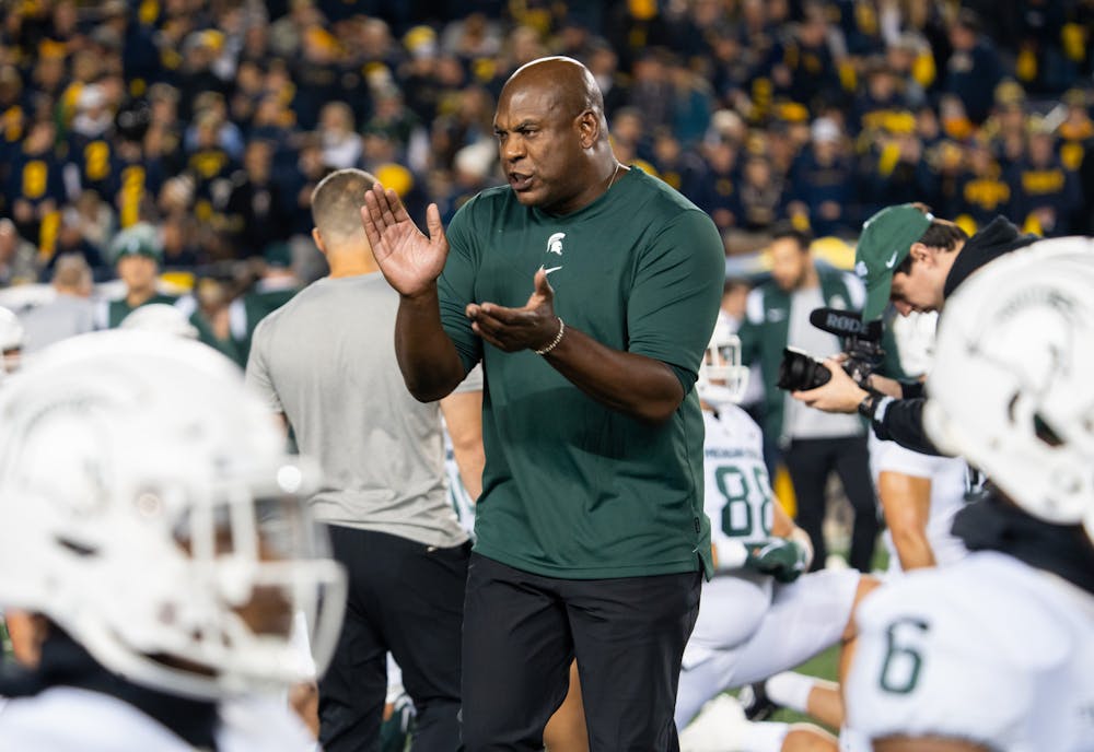 <p>Head Coach Mel Tucker encourages the team during warm-ups. The Spartans lost 29-7 to the Wolverines on Oct. 29, 2022.</p>
