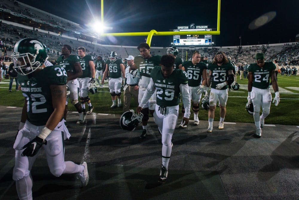 The team walks off the field after losing their homecoming game against Northwestern on Oct. 15, 2016 at Spartan Stadium. This was the fourth game in a row that the Spartans have lost. 