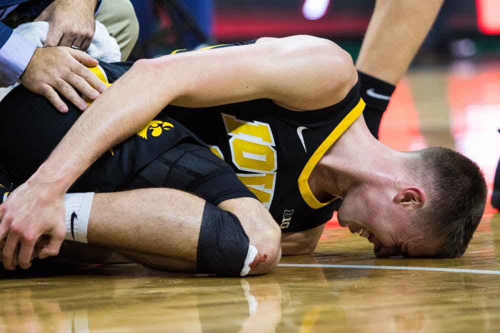 Iowa freshman guard Joe Wieskamp lies injured on the court during the game against Iowa University at Breslin Center on Dec. 3, 2018. The Spartans defeated the Hawkeyes, 90-68.
