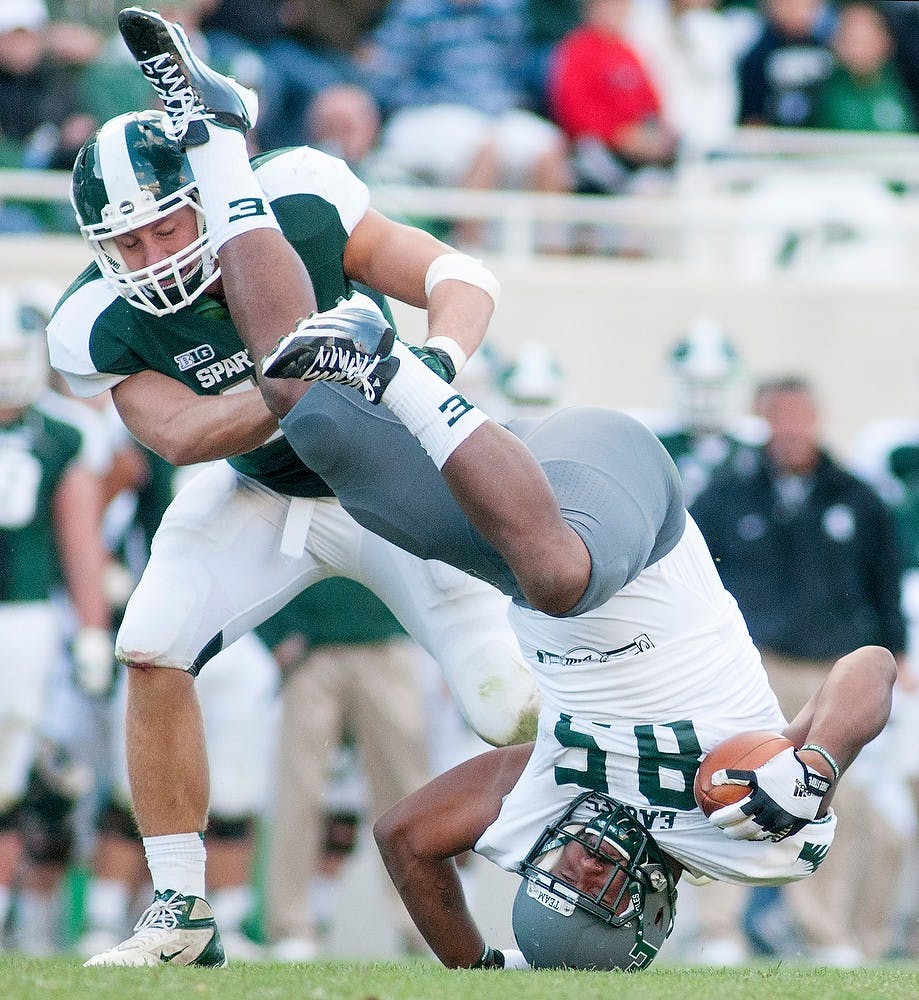 	<p>Eastern Michigan tight end Garrett Hoskins goes upside down with then-junior linebacker Max Bullough by his side. <span class="caps">MSU</span> defeated the Eastern Michigan, 23-7, on Saturday, Sept. 22, 2012 at Spartan Stadium. State News File Photo </p>