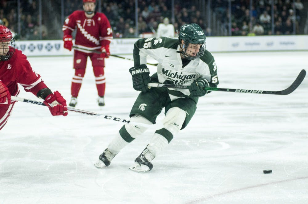 Freshman forward Patrick Khodorenko (55) takes the puck up the rink during the third period of the men's hockey game against Wisconsin on Feb. 4, 2017 at Munn Ice Arena. The Spartans were defeated by the Badgers, 3-4.
