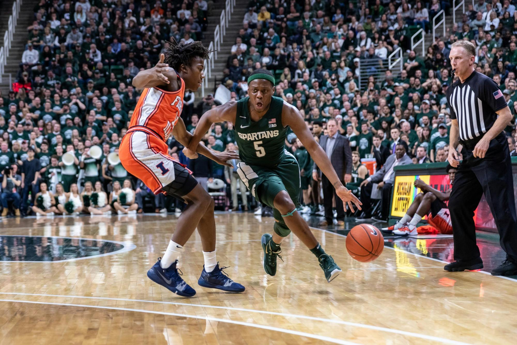 <p>Senior guard Cassius Winston (right) drives on Illinois guard Ayo Dosunmu (left). The Spartans defeated the Illini, 76-56, at the Breslin Student Events Center on January 2, 2020.</p>