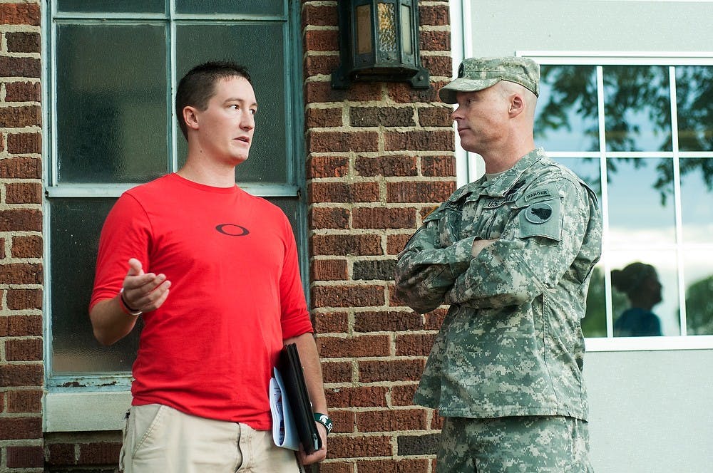 	<p>Economics junior Jerred Pender, left, speaks with Master Sergeant Ken Beach, right, during the <span class="caps">ROTC</span> Boot Camp 101 event, Sept. 11, 2013, outside of Demonstration Hall. Pender, as the president of the <span class="caps">MSU</span> Chapter of the Student Veterans of America, was advertising a<br />
welcoming event for student veterans. Danyelle Morrow/The State News</p>