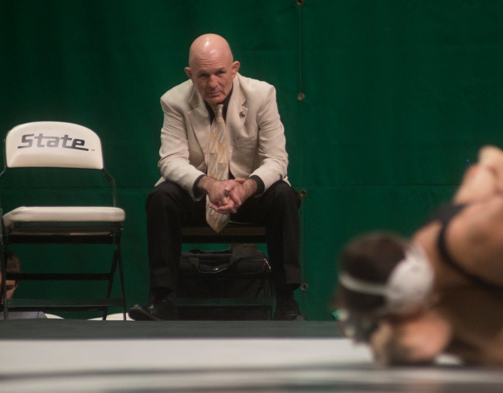 Head coach Tom Minkel watches a match during a meet against Eastern Michigan University on Dec. 2, 2015 at Jenison Field House. The Spartans were defeated by the Eagles, 34-0. 