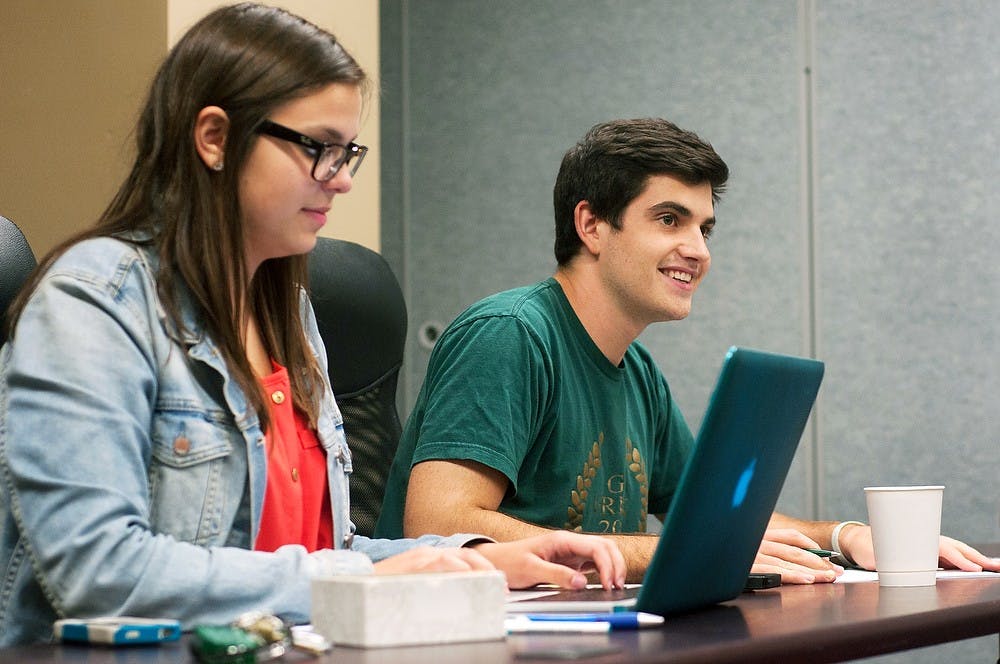 	<p><span class="caps">ASMSU</span> officials Teresa Bitner  and Michael Mozina listen during a meeting on Sept. 12, 2013 at Student Services. The undergraduate student government was conducting its first committees meeting of the year. Georgina De Moya/ The State News.</p>