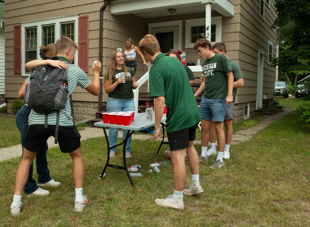 Students play beer pong at a tailgate in celebration of Michigan State's first football game on Sept. 3, 2021.