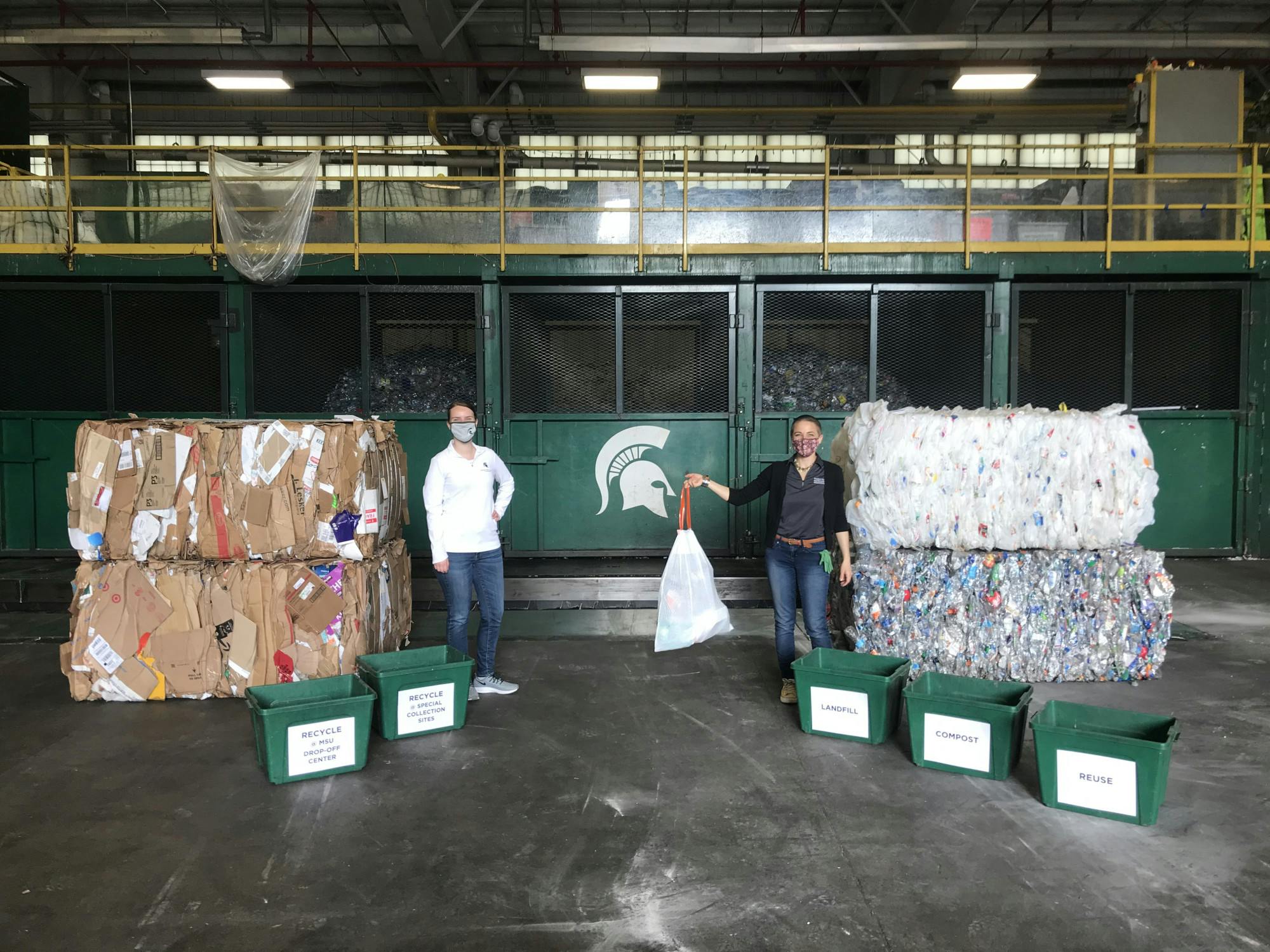 <p>Laura Young and Katie Deska inside the material recovery facility of the MSU Surplus Store &amp; Recycling Center. Photo courtesy of SSRC staff</p>