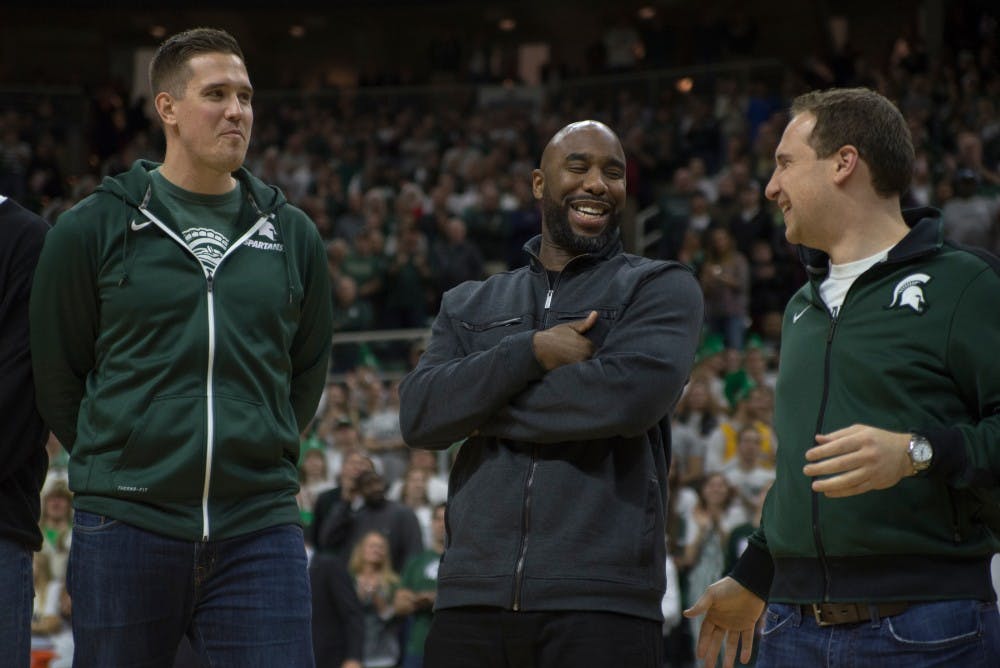 Former men's basketball players left to right, Jason Andreas, Mateen Cleaves and Matt Ishbia chat during halftime during the game against Florida on Dec. 12, 2015 at Breslin Center. The 2000 basketball team was honored during halftime.