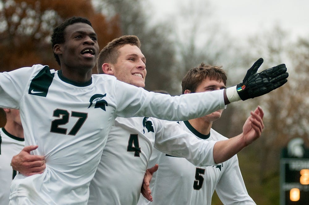 	<p>Junior midfielder Fatai Alashe, 27, junior forward Tim Kreutz, 4, and senior defender Ryan Thelen celebrate a goal against Michigan on Nov. 9, 2013, at DeMartin Stadium at Old College Field. The Spartans defeated the Wolverines, 2-0. Danyelle Morrow/The State News</p>