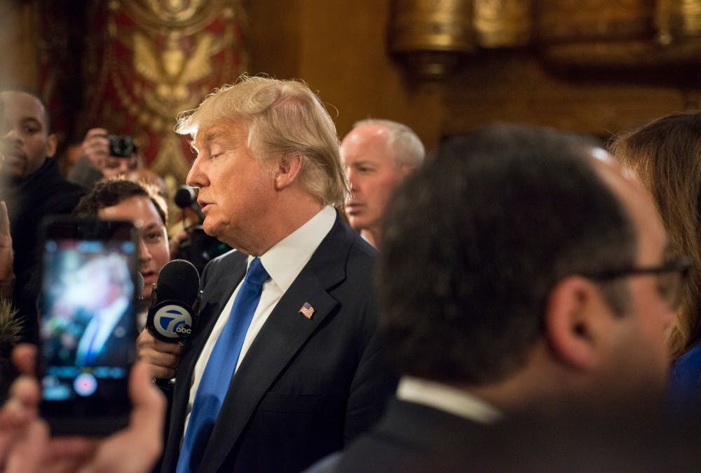 Businessman Donald Trump speaks to press in the spin room after the Republican Presidential Debate on March 3, 2016 at the Fox Theatre in Detroit.