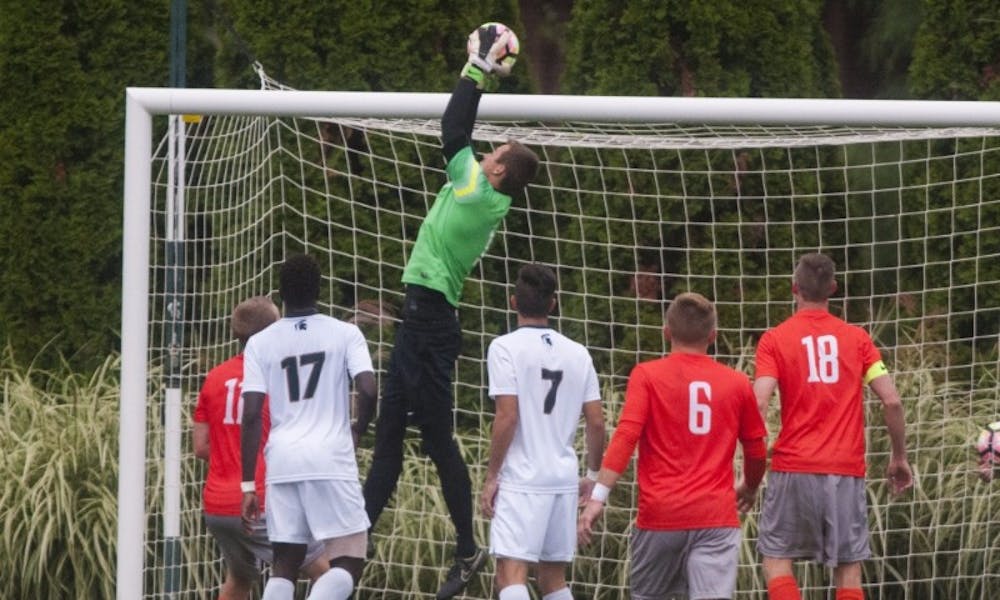 Sophomore goalie Jimmy Hague (1) jumps to catch the ball during the game against Bowling Green on Sept. 28, 2016. The Spartans defeated the Falcons, 1-0.