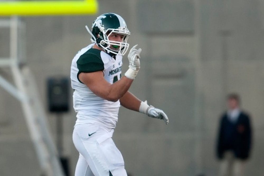 <p>Then-senior linebacker Max Bullough motions to the bench how close he was to intercepting the ball Oct. 26, 2013, at Memorial Stadium in Champaign, Ill. Bullough has been reportedly waived by the Houston Texans June 2. Julia Nagy/The State News</p>