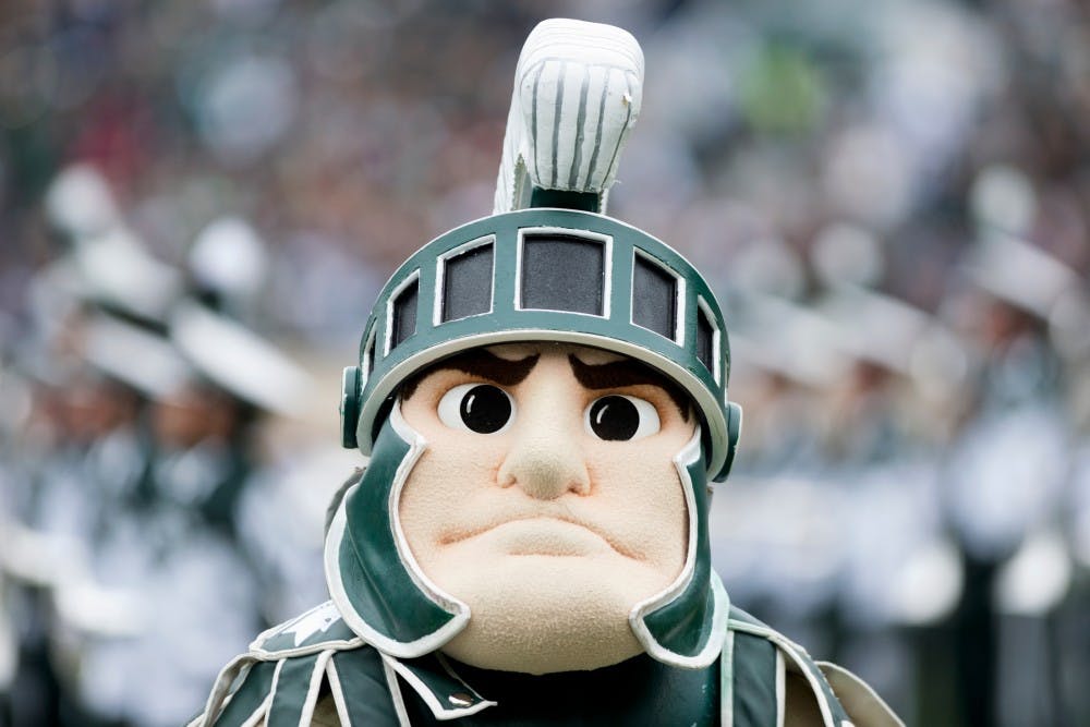 <p>Sparty cheers as the Spartan Marching Band performs prior to the Homecoming game against Purdue on Oct. 3, 2015, at Spartan Stadium. The Spartans defeated the Boilermakers,  24-21. </p>