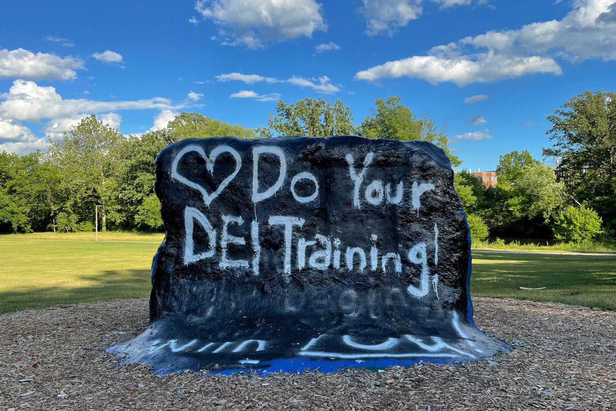 After The Rock was defaced for the eighth time, the phrase was quickly covered up with, "Do Your DEI Training".