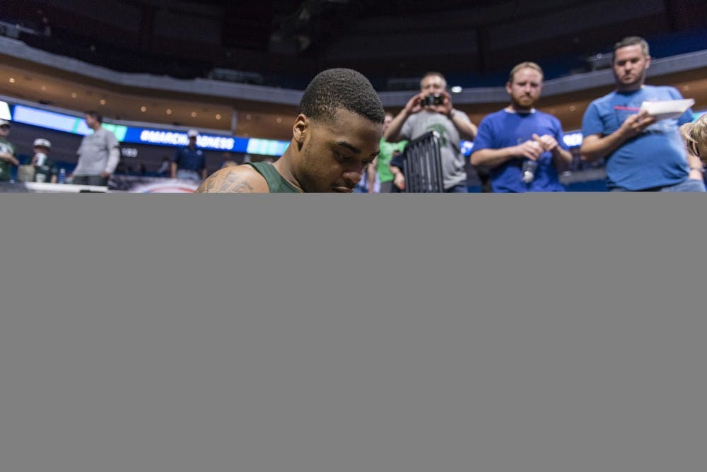 Freshman forward Nick Ward (44) signs a fan's pennant after the game against University of Miami (Fla.) in the first round of the Men's NCAA Tournament on March 17, 2017 at  at the BOK Center in Tulsa, Okla.The Spartans defeated  the Hurricanes, 78-58.