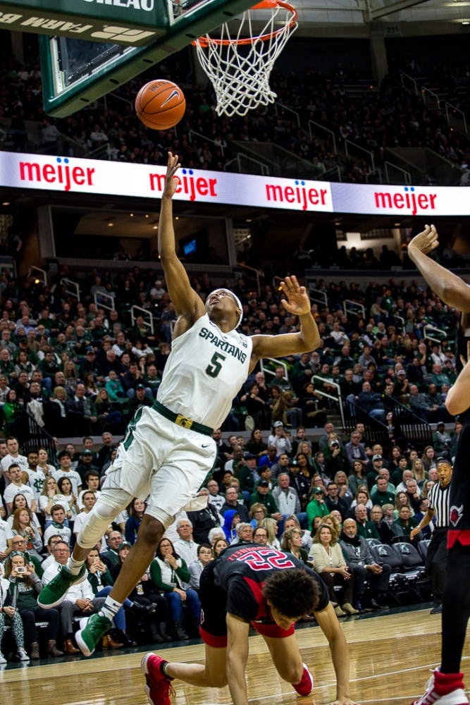 <p>Junior guard Cassius Winston (5) goes up for a shot during the game against Rutgers Feb. 20, 2019 at the Breslin Center. The Scarlet Knights led the Spartans, 32-25 at halftime.</p>