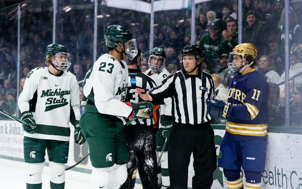 <p>The referee separates Michigan State's senior forward Jagger Joshua (23) and Notre Dame's graduate student forward Jackson Pierson (11) during a game against Notre Dame at Munn Ice Arena on Feb. 3, 2023. The Spartans defeated the Fighting Irish 3-0.</p>