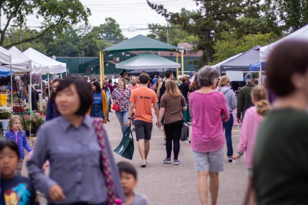 Customers walk through the Farmers' Market on June 3, 2018 at Valley Court Park.