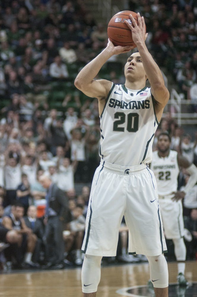<p>Senior guard Travis Trice attempts a free-throw Jan. 21, 2015, during a game against Penn State at Breslin Center. The Spartans defeated the Nittany Lions, 60-66. Alice Kole/The State News</p>
