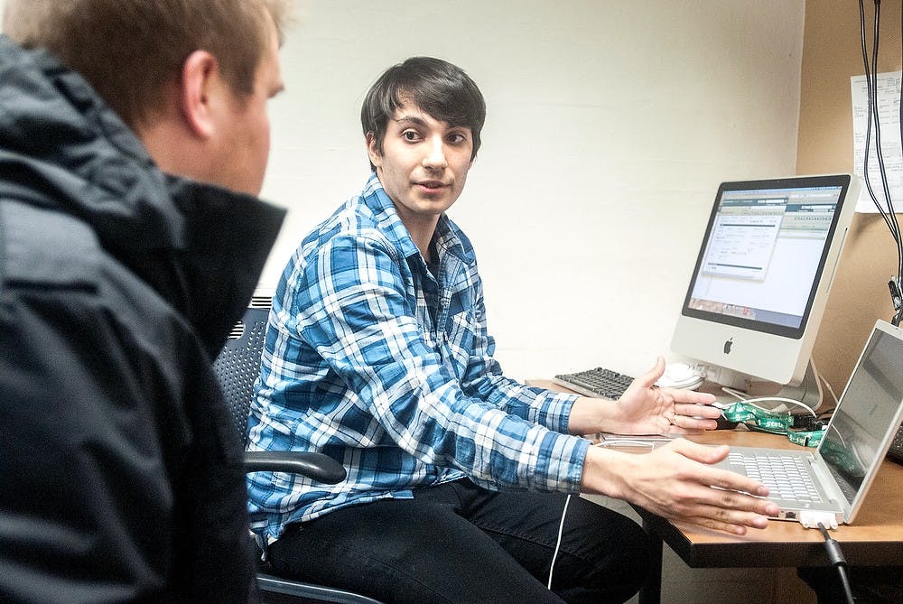 	<p>Computer engineering senior and IT Services employee Pedro Rodriguez talks with packaging senior Jack Sherwood about an issue with his computer Feb. 11, 2013, at the Computer Center. Technology at <span class="caps">MSU</span> is becoming a more integrative part of the learning environment. Adam Toolin/The State News</p>