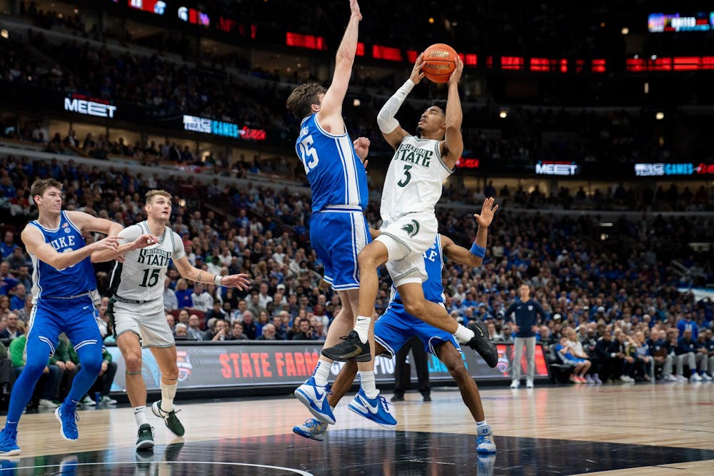 Junior guard Jaden Akins (3) leaps to score during the Champions Classic at the United Center on Nov. 14, 2023. The Spartans fell to the Blue Devils with a score of 74-65. 