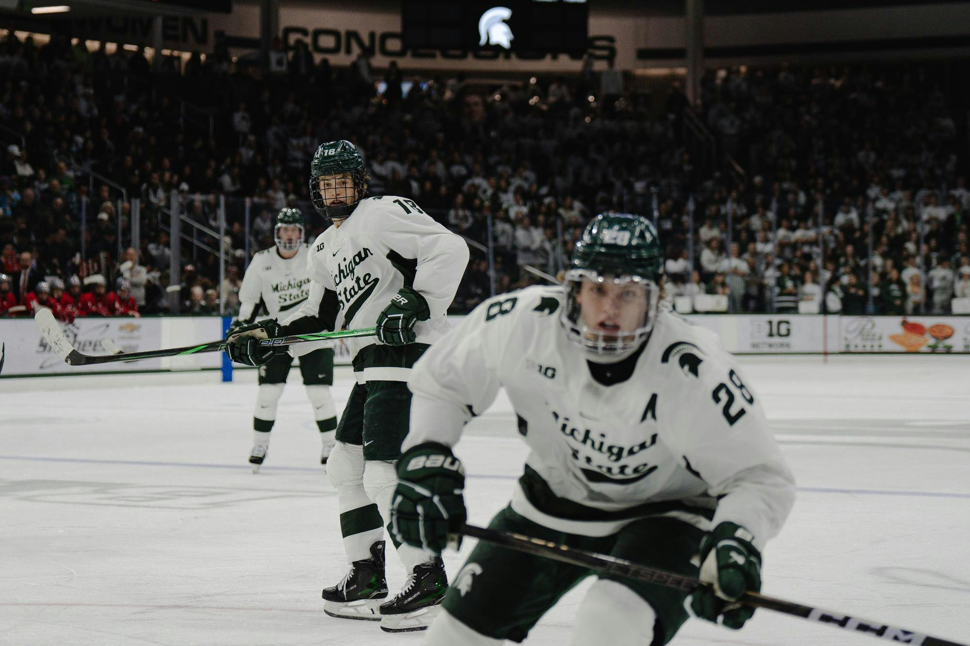 <p>MSU junior forward Joey Larson (18) and junior forward Karsen Dorwart (28) look for the puck in a game against Ohio State at Munn Ice Arena on Nov. 8, 2024</p>