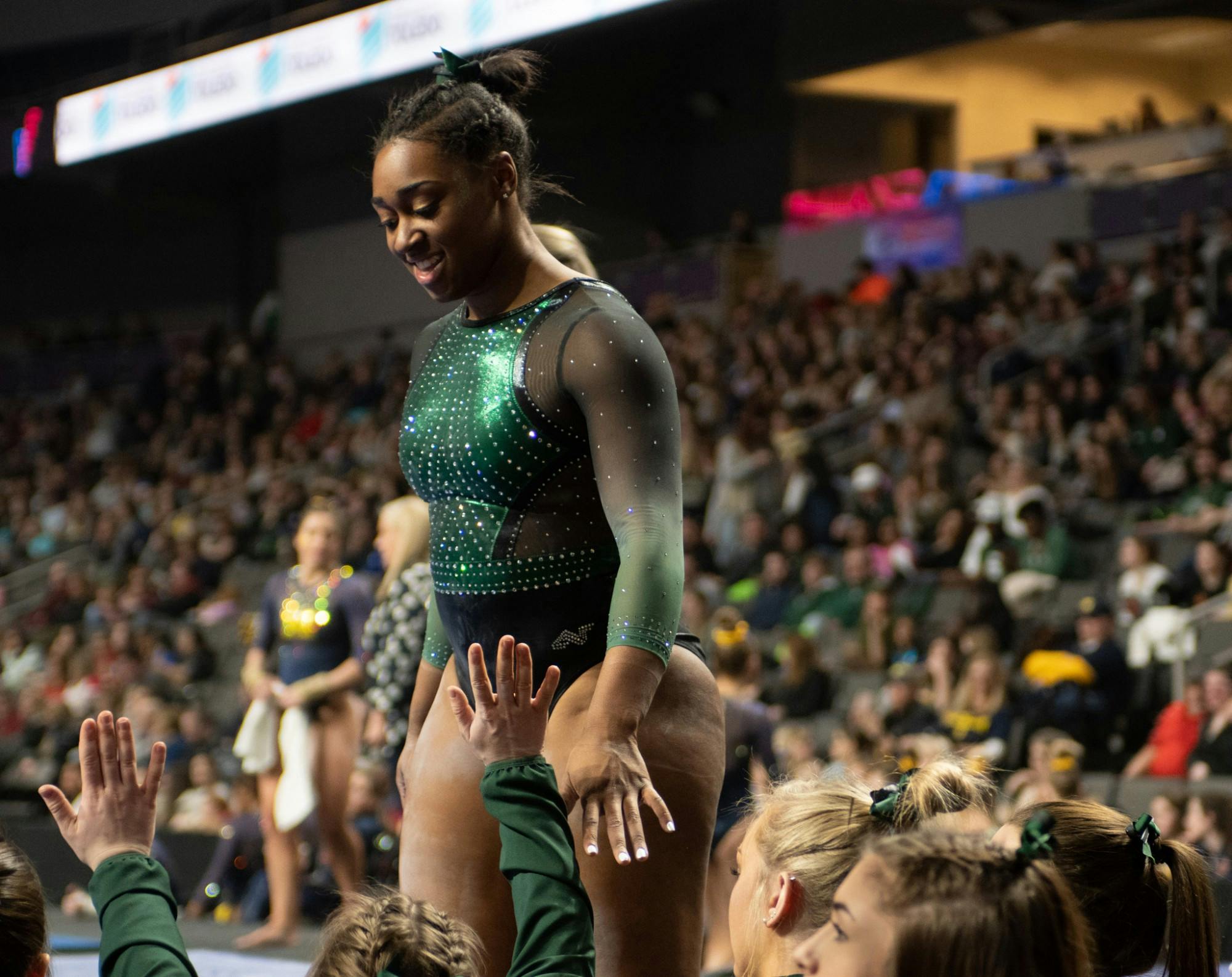 <p>Sophomore Alaina Raybon high fives her teammates Feb. 22, 2020, during Elevate the Stage at the Huntington Center in Toledo, Ohio. </p>