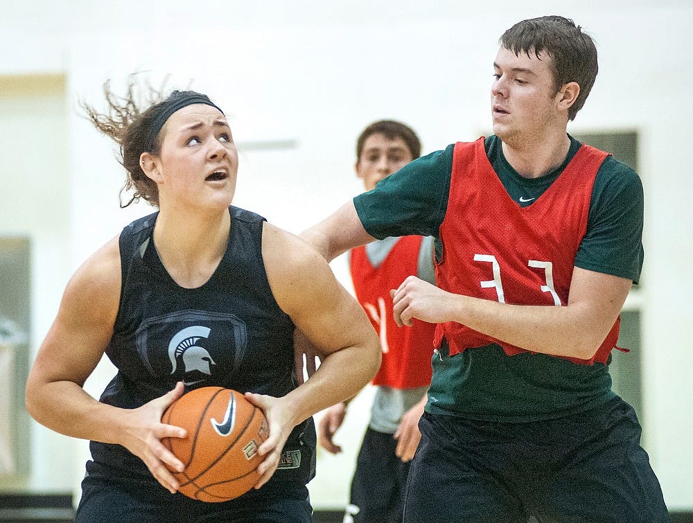 	<p>Sophomore center Jasmine Hines, left, looks for a shot during practice as food industry management junior and scout team member Marc Kanitz plays defense. Kanitz said he heard the scout team position through word of mouth, and has since brought his friends who are qualified to be on the team on board. Justin Wan/The State News</p>