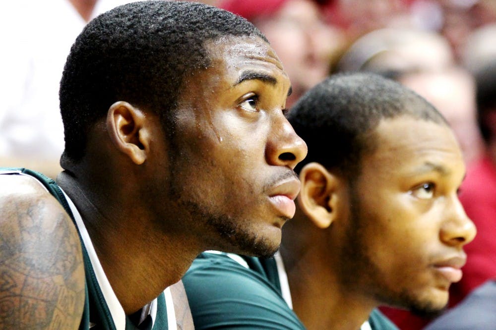 From left, freshman guard Branden Dawson and sophomore center Adreian Payne watch the final seconds count down game from the bench Tuesday night at Assembly Hall. The spartans were defeated by Indiana with a score of 70-55. Aaron Snyder/The State News. 