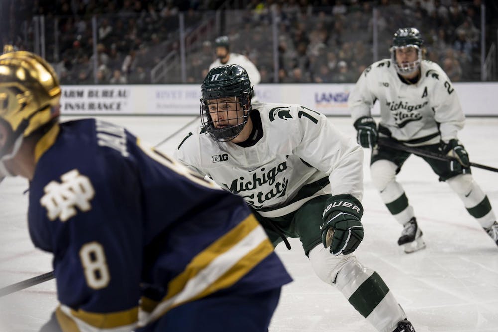 <p>Michigan State University freshman defenseman Owen West (11) skates after Notre Dame senior forward Justin Janicke (8) at Munn Ice Arena on Nov. 16, 2024.</p>