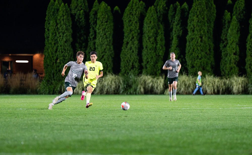 <p>MSU midfielder Jack Guggemos (left) and Oakland midfielder Mohamed Hammoud race to the ball at DeMartin Soccer Complex on Sept. 26, 2023. Hammoud recorded one assist in the matchup against Michigan State.</p>