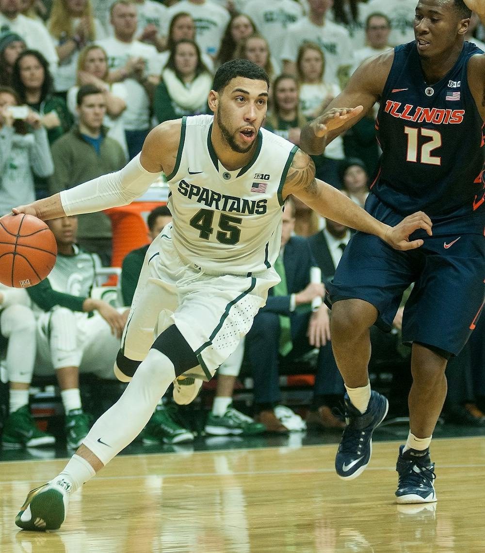 <p>Junior guard Denzel Valentine dribble the ball towards the basket around Illinois forward Leron Black Feb. 7, 2015, during the game against Illinois at Breslin Center. The Spartans were defeated by the Fighting Illini, 59-54. Erin Hampton/The State News</p>