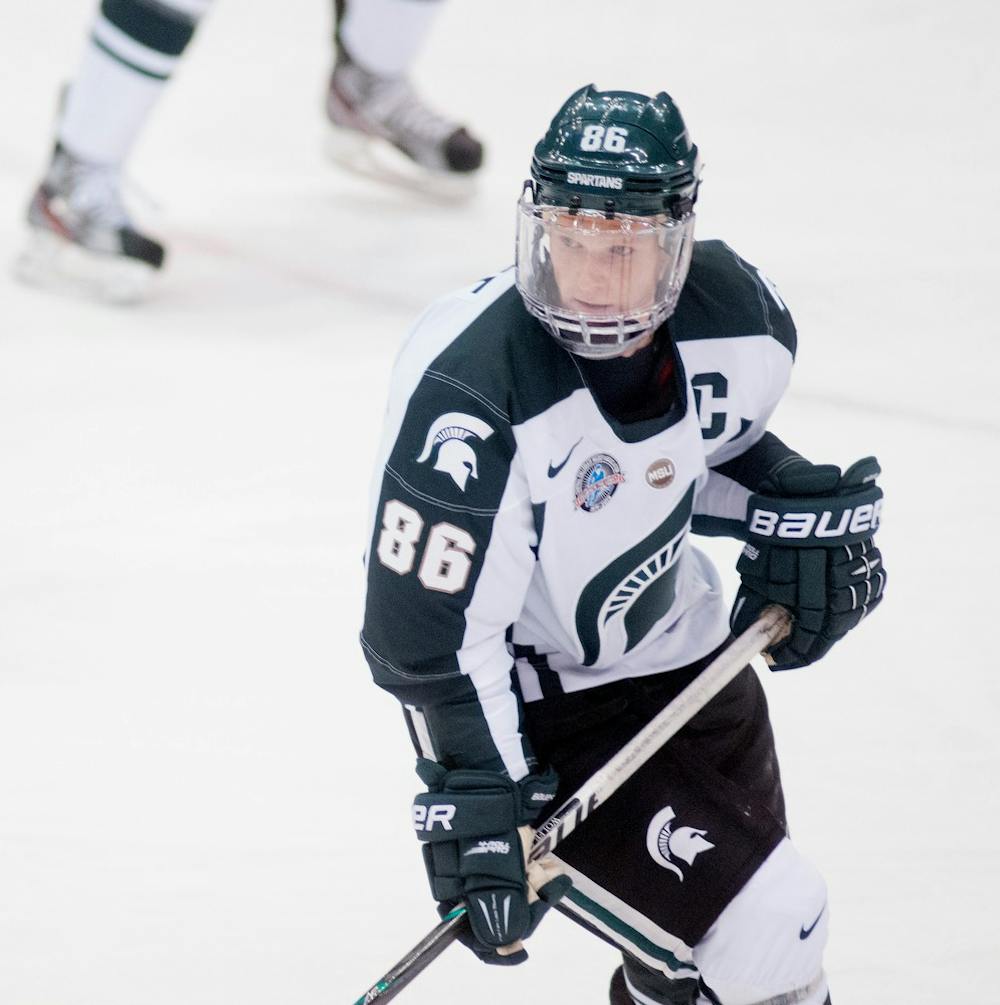 Junior forward Greg Wolfe skates to the puck during the game against Niagara, which ended in a 3-3 tie, on Saturday evening, Oct. 20, 2012, at Munn Ice Arena. Wolfe contributed one goal and one assist during the game. Natalie Kolb/The State News