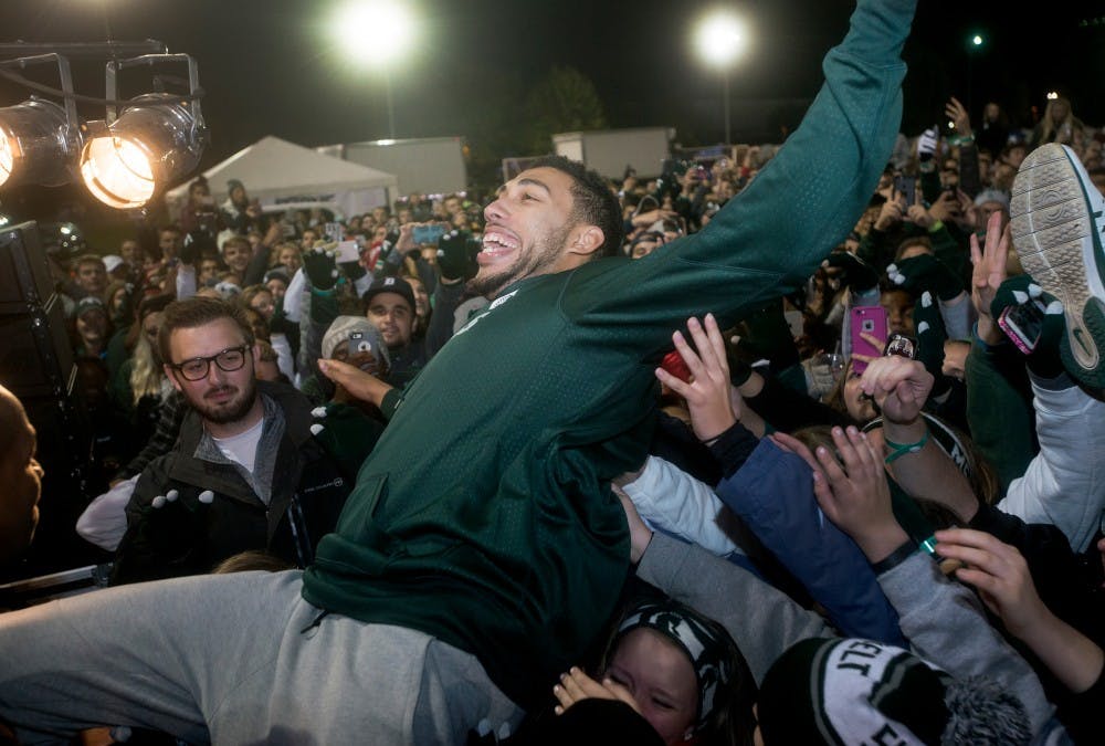 <p>Senior guard Denzel Valentine crowd surfs on Oct. 9, 2015, during the Izzone Campout at Munn Field. This annual event consists of students staying throughout the night in hopes of getting lower bowl seating. </p>