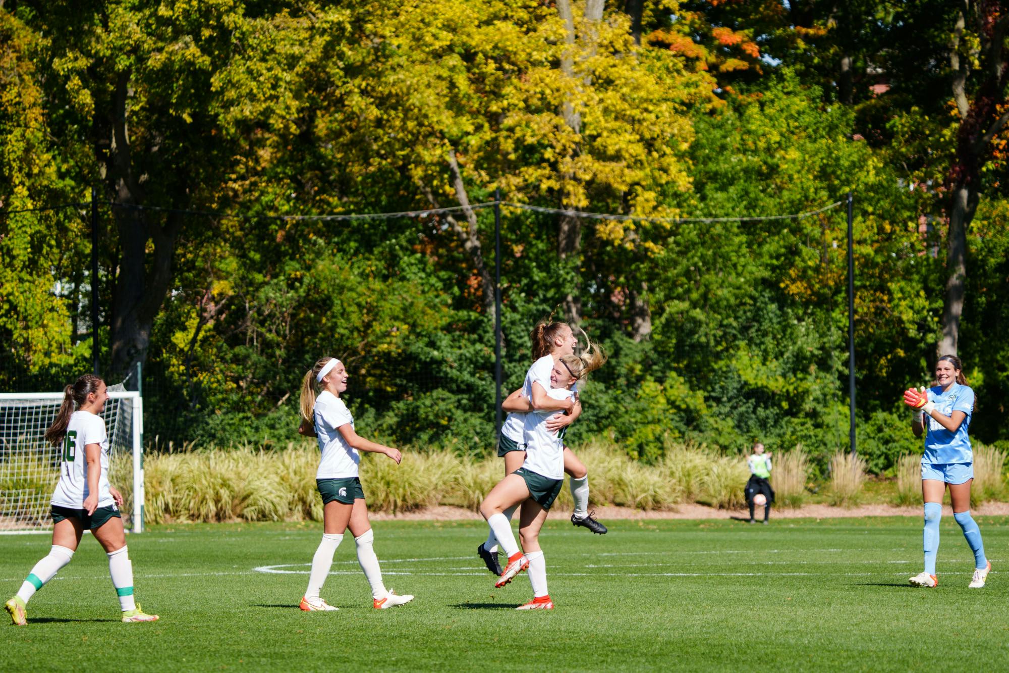 <p>Michigan State women&#x27;s soccer players embrace, celebrating an early goal in a game against University of Michigan at DeMartin Stadium on Oct. 9, 2022. The Spartans defeated the Wolverines 2-0.</p>