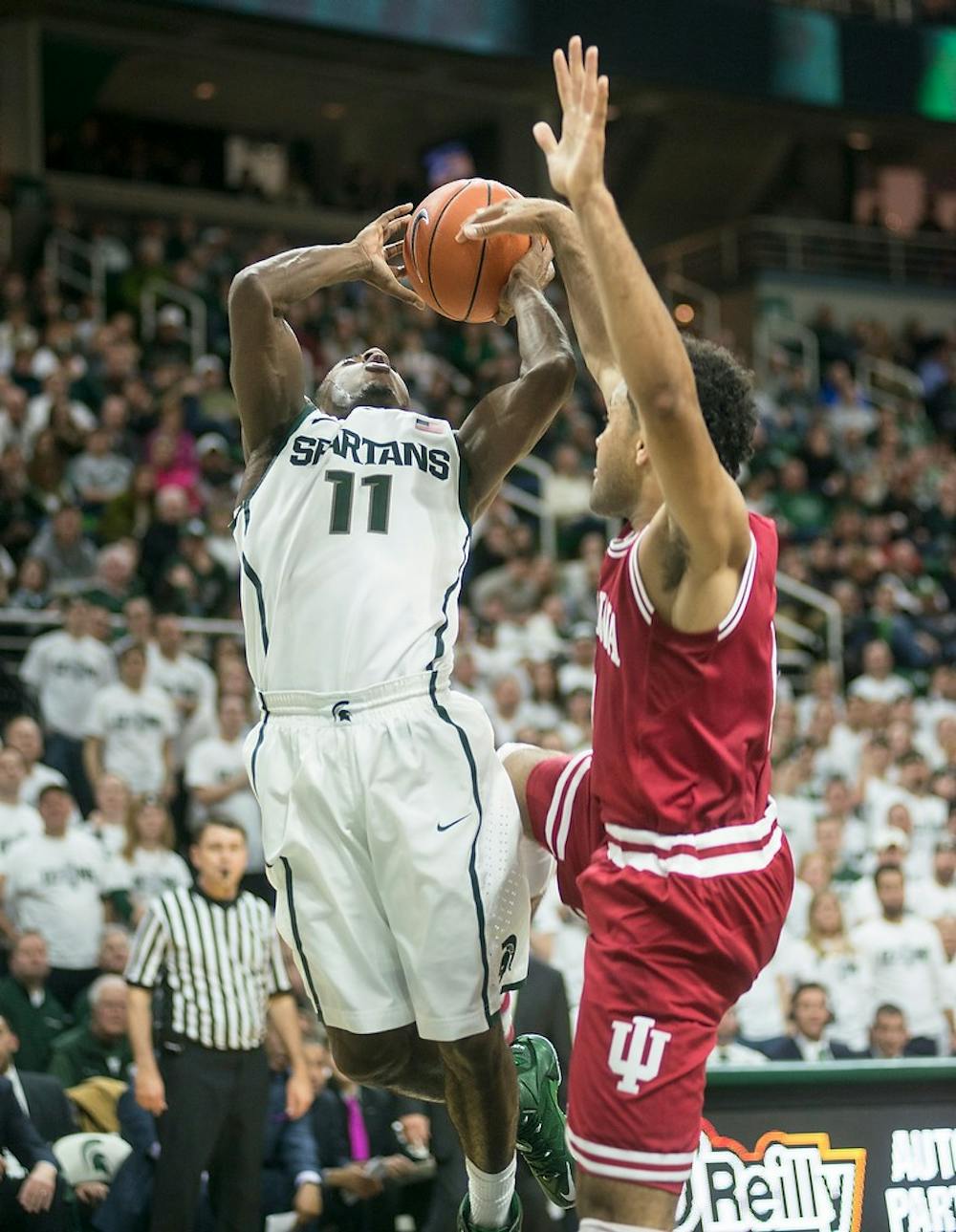 <p>Freshman guard Lourawls 'Tum Tum' Nairn Jr. attempts a point Jan. 5, 2014, during the game against Indiana at Breslin Center. The Spartans defeated the Hoosiers, 70-50. Erin Hampton/The State News</p>