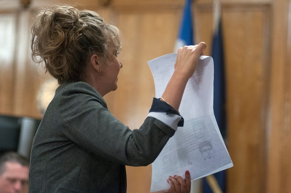 <p>Ingham County Assistant Prosecutor Kimberly Hesse addresses the jury and presents the lineup of photos Yan Li had looked over before identifying Meng Long Li and Shan Gao as his attackers Feb. 2, 2015, at 30th Circuit Court in the Ingham County Courthouse, 315 S. Jefferson St., Mason, Michigan. She says that only the testimonies of Yan Li and his girlfriend are honest and that there are inconsistencies in the statements of the defendants and witnesses for the defense. Allyson Telgenhof/The State News. </p>