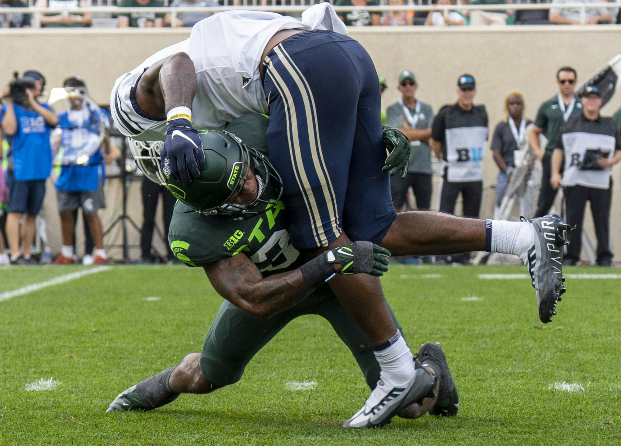 <p>Senior cornerback Kendell Brooks, 33, tackles TJ Banks, 5, for a turnover during Michigan State’s game against Akron on Saturday, Sept. 10, 2022 at Spartan Stadium. </p>
