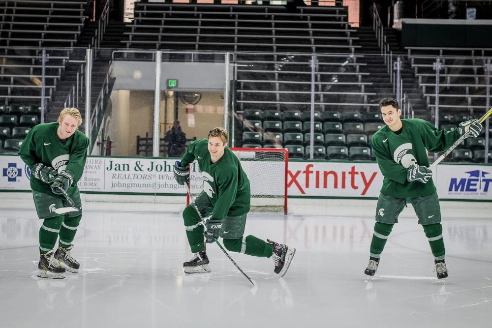 Michigan State University men's hockey leading scorers, from left, freshman forward Mitch Lewandowski, sophomore forward Patrick Khodorenko, and sophomore forward Taro Hirose, show parts of their slap shots prior to practice on Jan. 17, 2018 at Munn Ice Arena. (C.J. Weiss | The State News) 