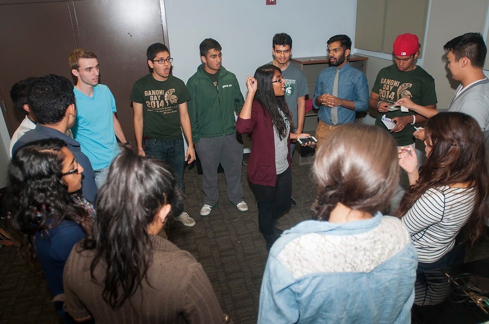 <p>Members of acapella group Spartan Sur warm up before on Oct. 26, 2014, in the basement of Synder-Phillips hall. Each week every individual is given a solo assignment to work on and preform in the next practice. Jessalyn Tamez/The State News</p>