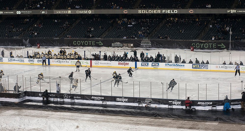 <p>The Spartans held control of the puck Feb. 7, 2015, during the game against Michigan at Soldier Field in Chicago, Illinois.  The Spartans were defeated by the Wolverines, 4-1, during the Coyote Logistics Hockey City Classic. Alice Kole/The State News</p>